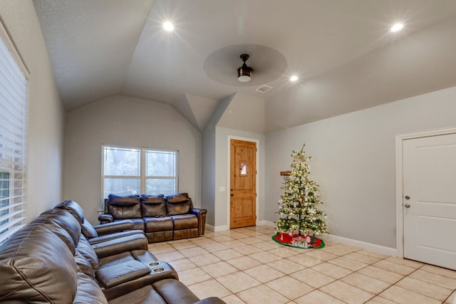 tiled living room featuring ceiling fan and vaulted ceiling