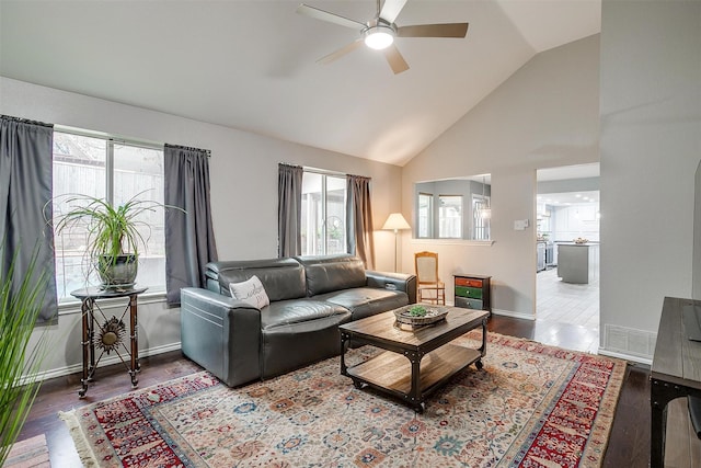 living room with ceiling fan, vaulted ceiling, and hardwood / wood-style flooring