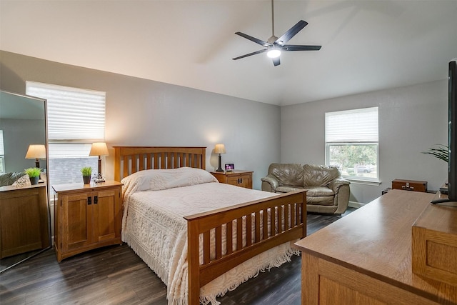 bedroom with ceiling fan, dark hardwood / wood-style floors, and vaulted ceiling