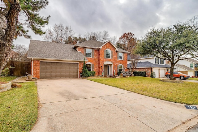 view of front of property with an attached garage, brick siding, a shingled roof, driveway, and a front yard