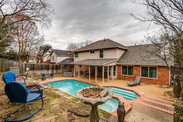 view of pool featuring an in ground hot tub