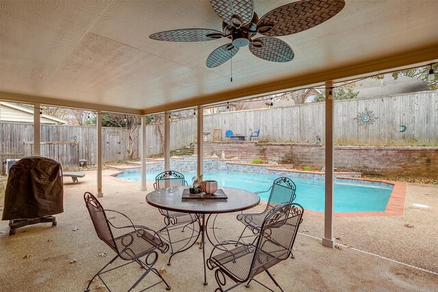 view of swimming pool with an in ground hot tub, a patio, and central AC unit