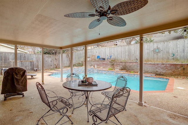 view of pool with a patio area and ceiling fan