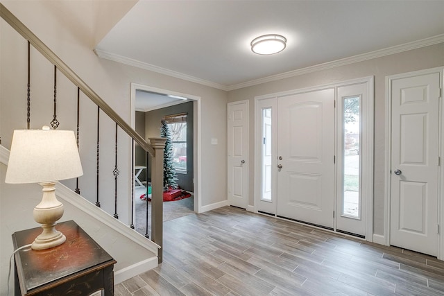 entrance foyer featuring wood-type flooring and ornamental molding