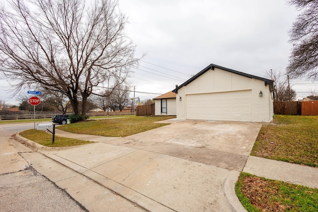 view of side of property with a garage and a lawn