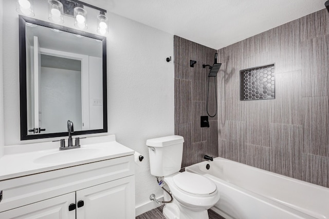 full bathroom with vanity, tiled shower / bath combo, and toilet