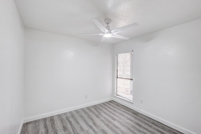 unfurnished room featuring ceiling fan and light hardwood / wood-style flooring