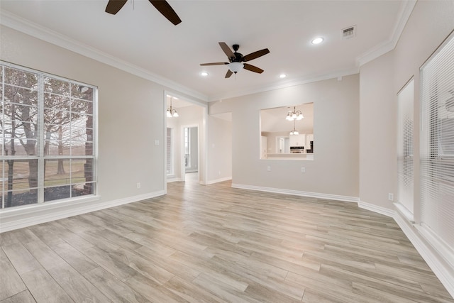 unfurnished living room with crown molding, ceiling fan with notable chandelier, and light wood-type flooring