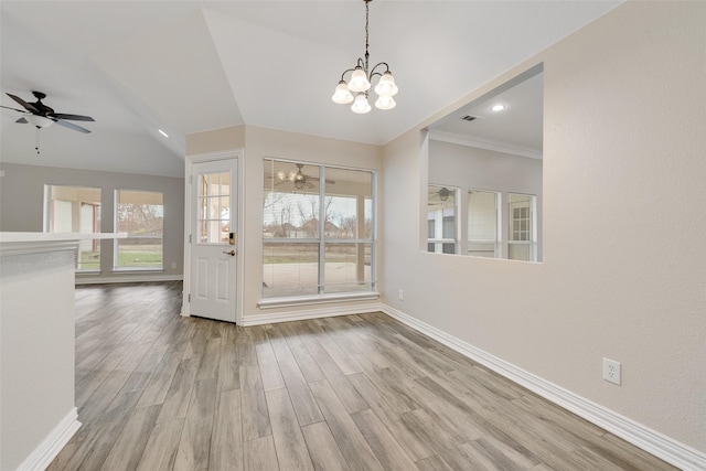 interior space featuring ceiling fan with notable chandelier, light hardwood / wood-style floors, crown molding, and a wealth of natural light