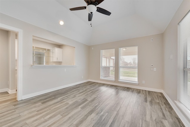 empty room featuring lofted ceiling, light hardwood / wood-style flooring, and ceiling fan