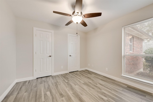 unfurnished bedroom with ceiling fan and light hardwood / wood-style floors