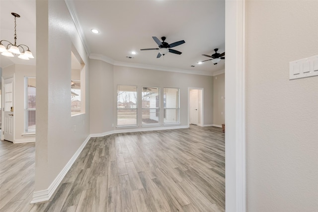 empty room featuring ceiling fan with notable chandelier, light hardwood / wood-style floors, and ornamental molding