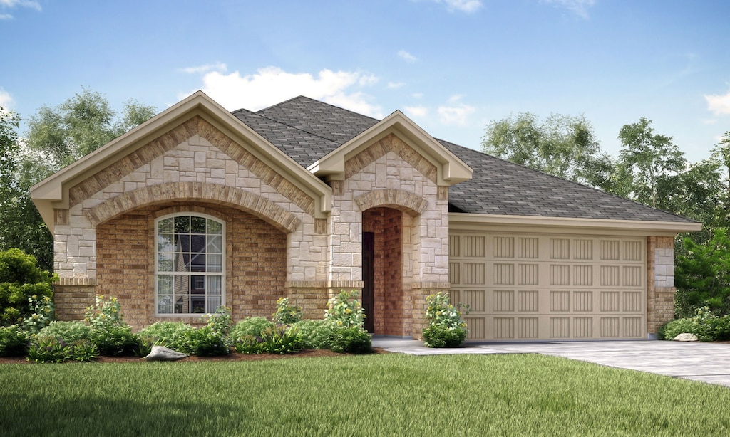 view of front of home with a garage and a front lawn