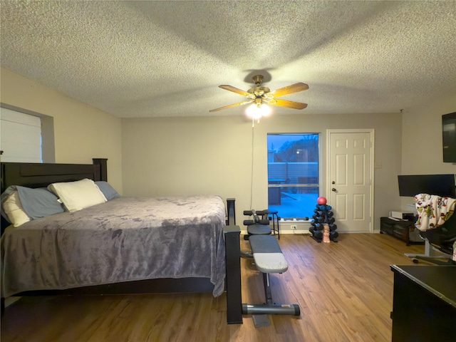 bedroom featuring a textured ceiling, hardwood / wood-style flooring, and ceiling fan