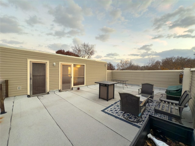 view of patio with an outdoor living space with a fire pit