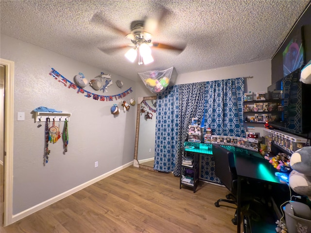 office space featuring hardwood / wood-style floors, ceiling fan, and a textured ceiling