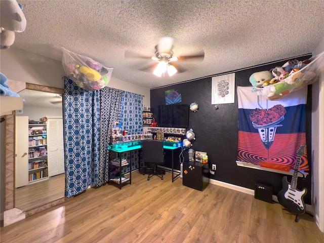 office with hardwood / wood-style floors, ceiling fan, and a textured ceiling