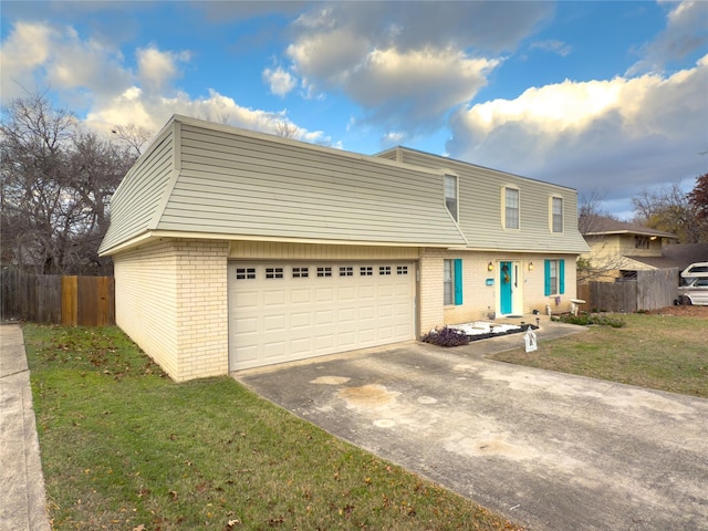 view of front of house featuring concrete driveway, an attached garage, fence, a front lawn, and brick siding