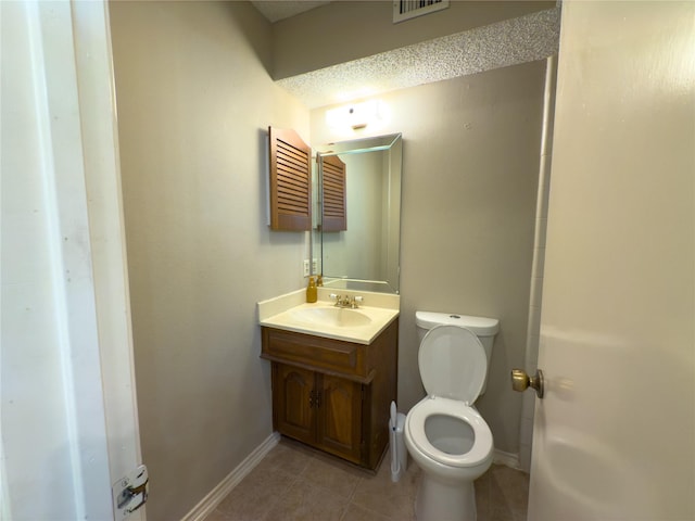 bathroom featuring visible vents, baseboards, toilet, tile patterned floors, and vanity