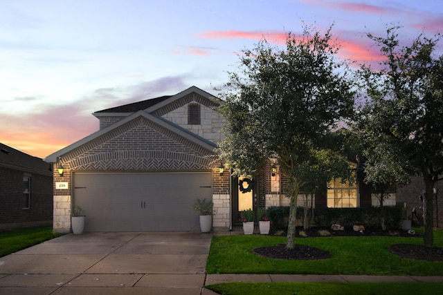 view of front of property with a lawn and a garage