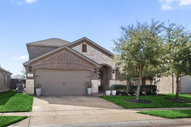 view of front facade with a garage and a front lawn