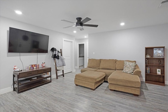 living room featuring light wood-type flooring and ceiling fan