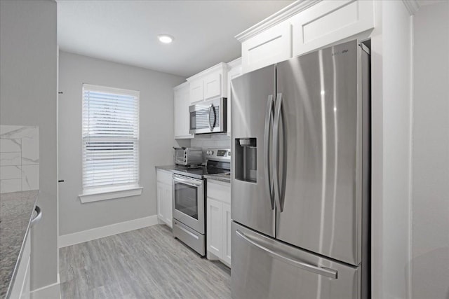 kitchen featuring decorative backsplash, stainless steel appliances, stone countertops, light hardwood / wood-style flooring, and white cabinetry