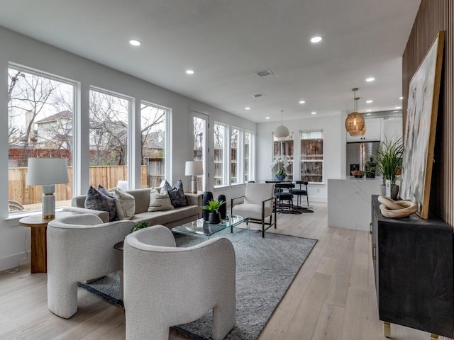 living room with a fireplace and light hardwood / wood-style flooring