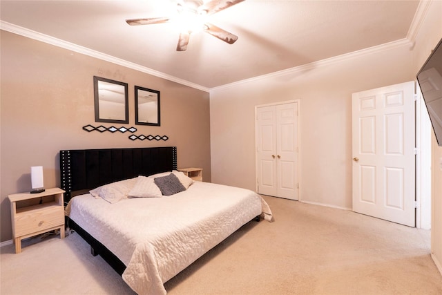 bedroom featuring crown molding, light carpet, ceiling fan, and a closet