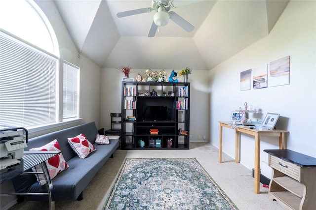 carpeted living room featuring ceiling fan and vaulted ceiling