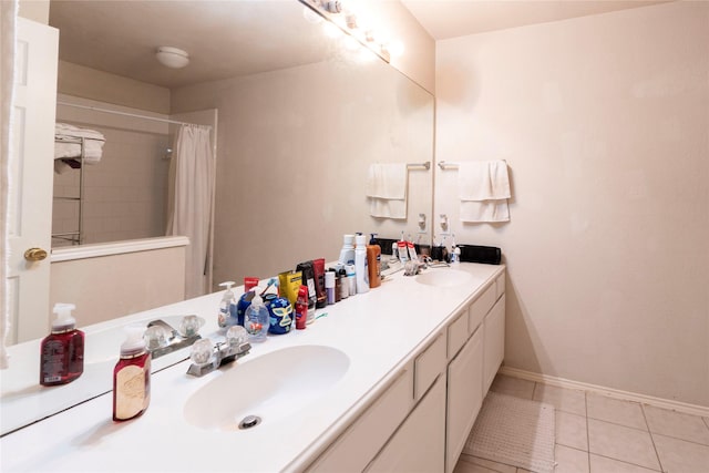 bathroom with a shower with curtain, vanity, and tile patterned flooring