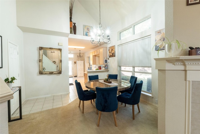 tiled dining room with high vaulted ceiling, a wealth of natural light, and a chandelier