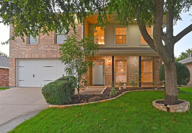 view of front of home with concrete driveway, an attached garage, brick siding, and a front yard