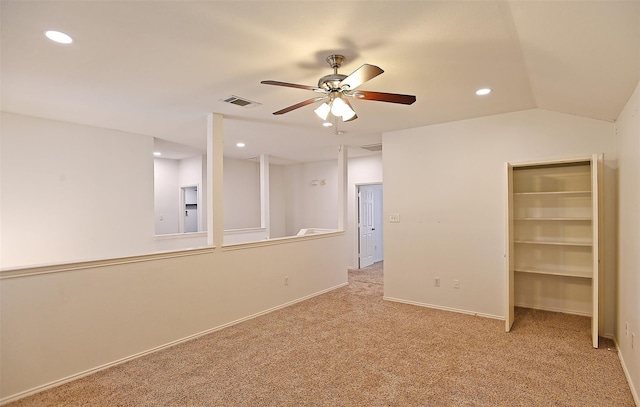 carpeted empty room featuring ceiling fan and vaulted ceiling