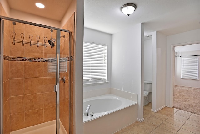 bathroom with tile patterned flooring, separate shower and tub, and toilet