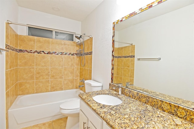 full bathroom with tiled shower / bath combo, vanity, tile patterned flooring, and toilet