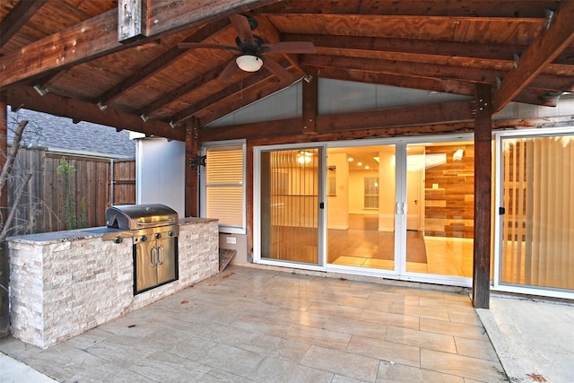 view of patio / terrace with area for grilling, ceiling fan, and exterior kitchen