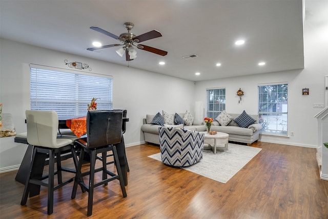 living room featuring hardwood / wood-style flooring and ceiling fan