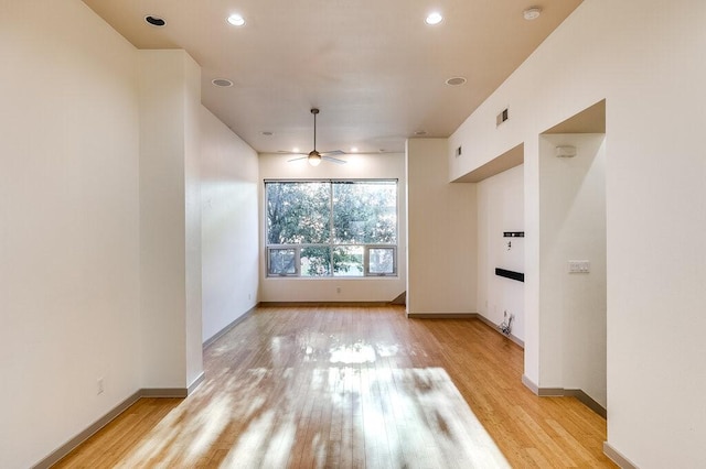 interior space with light wood-type flooring and ceiling fan