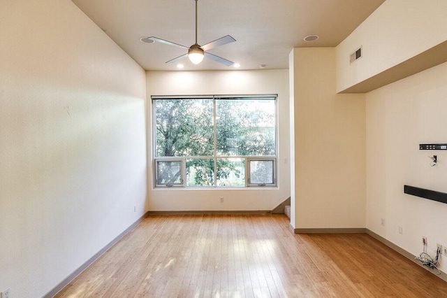 unfurnished room with ceiling fan and light hardwood / wood-style floors