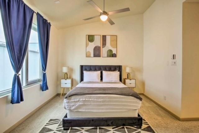 bedroom with ceiling fan, carpet floors, and vaulted ceiling