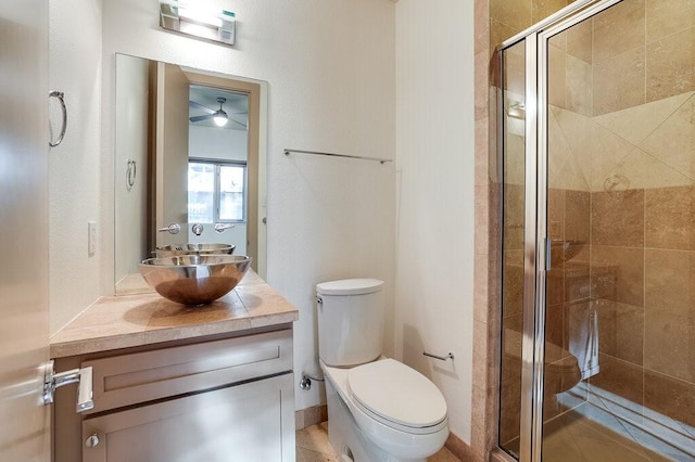 bathroom featuring vanity, toilet, and walk in shower