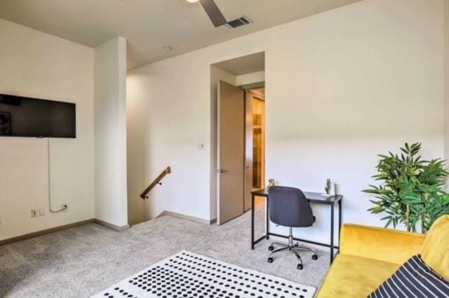 home office featuring ceiling fan and light colored carpet