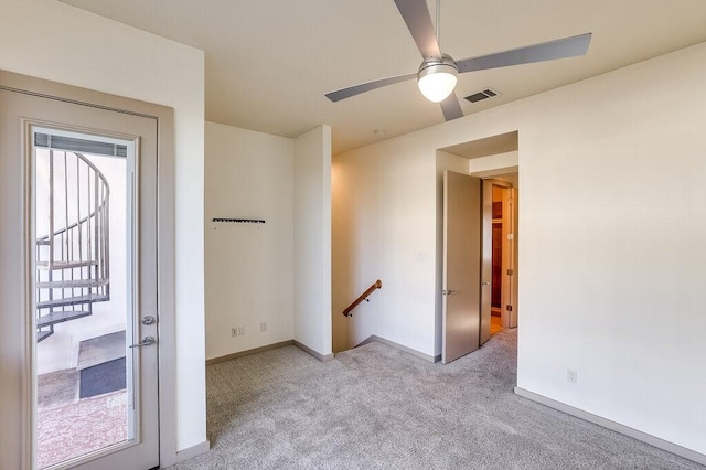 carpeted empty room with ceiling fan and a healthy amount of sunlight