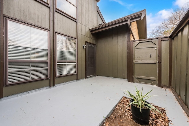 view of exterior entry with a patio