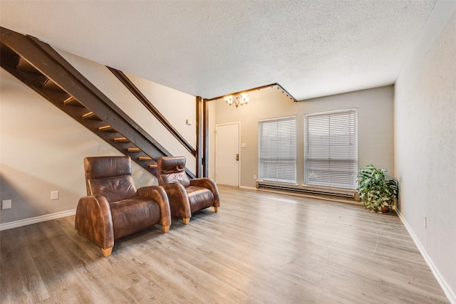 sitting room featuring light hardwood / wood-style floors and a textured ceiling