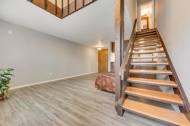 stairs featuring hardwood / wood-style floors