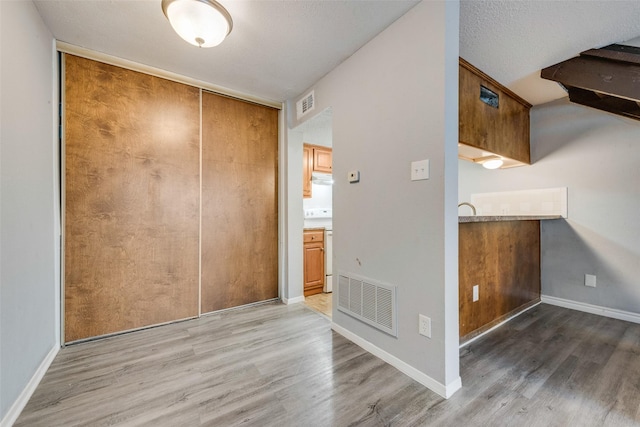 interior space with hardwood / wood-style floors and a textured ceiling