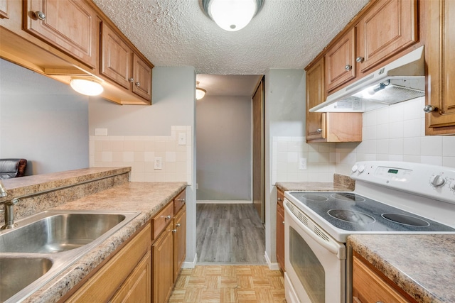 kitchen with a textured ceiling, tasteful backsplash, white electric stove, and sink