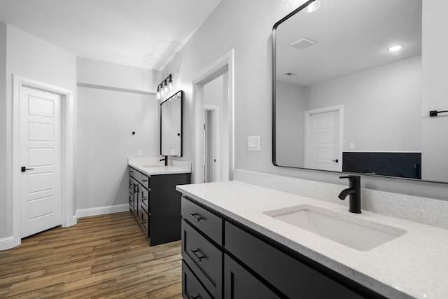 bathroom with hardwood / wood-style floors and vanity